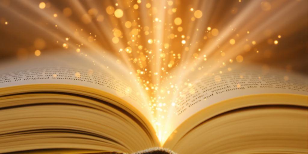 Open book with light beams and glowing particles.